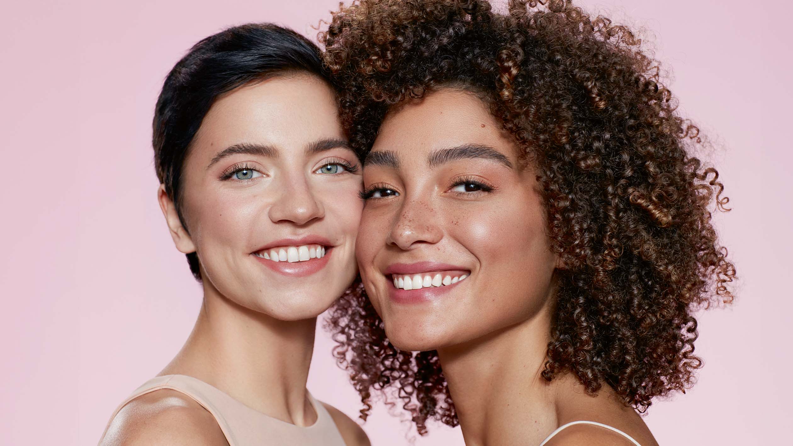 Two smiling female models looking into the camera